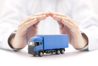 blue toy semi truck in hands of insurance adjuster