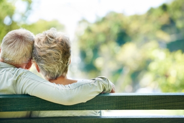 elderly couple on park bench