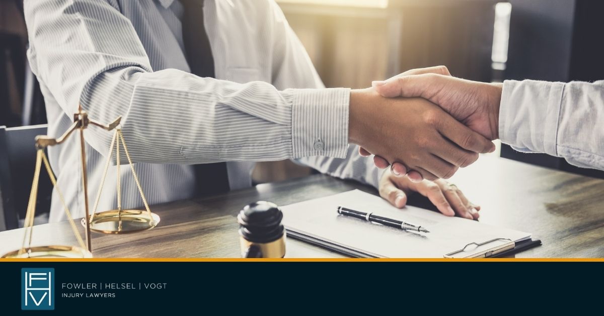 two men wearing business attire shaking hands
