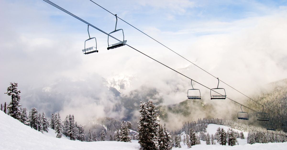wide view of a ski lift going over a mountain