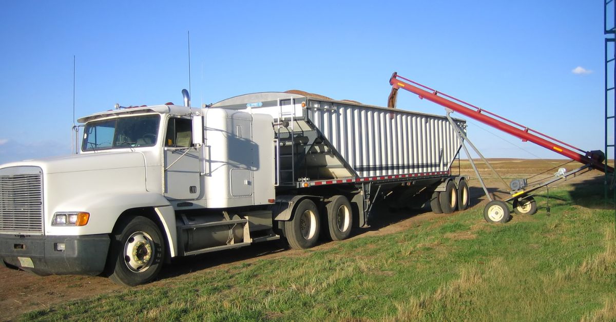 grain truck being filled in an open outdoor space
