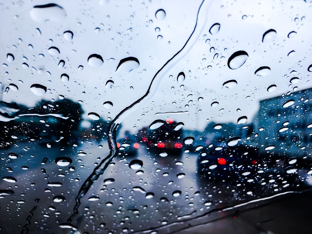 Cars on a wet road through a windshield