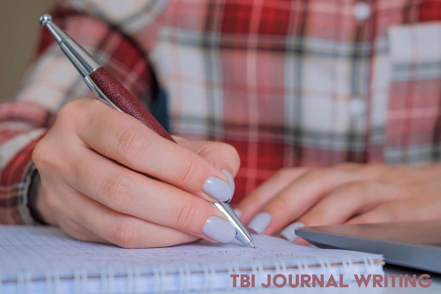 girl writing in her TBI journal